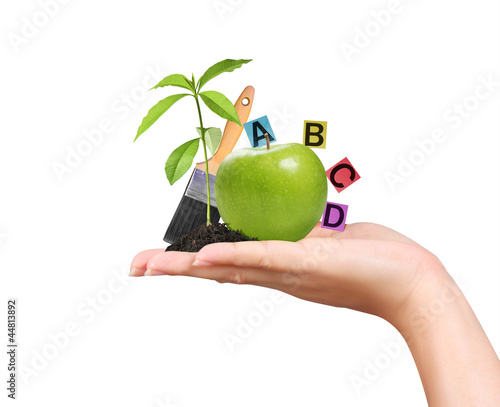 Photo: hand with green apple and educational ideas on a white backgroun hand with green apple and educational ideas on a white backgroun