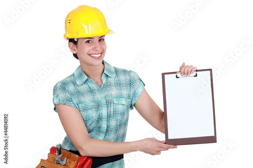 Photo: Woman pointing to clip-board Woman pointing to clip-board
