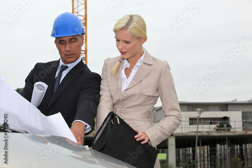 Photo: Architect and assistant visiting construction site Architect and assistant visiting construction site