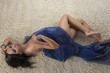 sexy girl lying on the carpet with blue cloth turned on the righ
