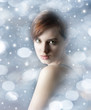 young woman with nice face on snowing background