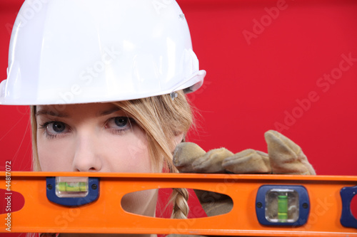 Photo: Female manual worker with spirit level Female manual worker with spirit level