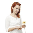 Foto: young beautiful red haired girl is playing he loves me young beautiful red haired girl is playing he loves me