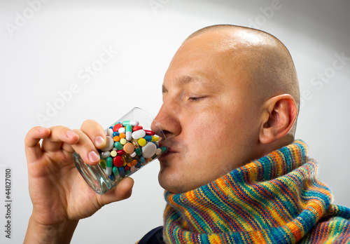 Photo: Man drinking pills Man drinking pills