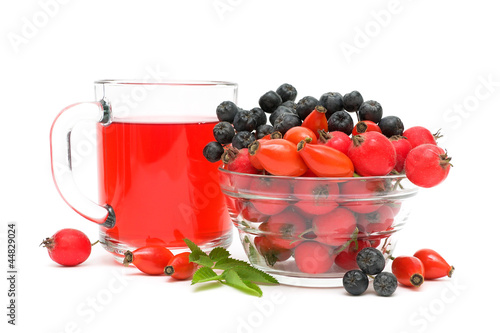 Photo: cup of tea with rose hips and different berries close up cup of tea with rose hips and different berries close up