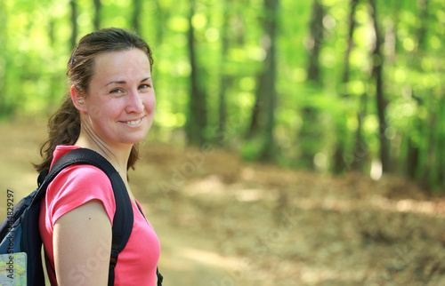 Photo: Smiling woman hiking in forest Smiling woman hiking in forest