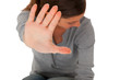 teenage girl  holding hand up to block violence