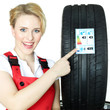 Female car mechanic showcases tire label
