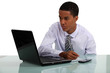 Young businessman looking at his laptop