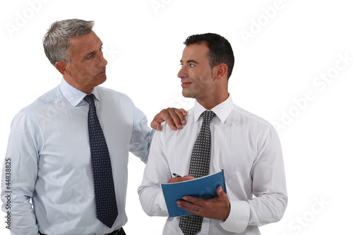 Photo: Two businessmen with a report Two businessmen with a report