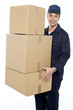 Working man delivering stack of cardboard boxes