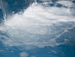 Close up of water splashing into swimming pool