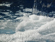 Close up of water splashing into swimming pool