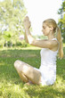 Portrait of young woman practicing yoga in grass