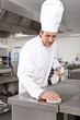 Chef cleaning work surface in commercial kitchen