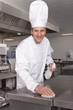 Chef cleaning work surface in commercial kitchen