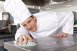 Chef cleaning work surface in commercial kitchen
