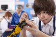 Student working on robotic device in vocational class