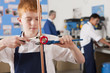 Photo: Student using wrench to tighten valve on cooper plumbing pipe Student using wrench to tighten valve on cooper plumbing pipe