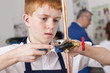 Photo: Student using wrench to tighten valve on cooper plumbing pipe Student using wrench to tighten valve on cooper plumbing pipe