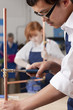 Photo: Student using wrench to tighten valve on cooper plumbing pipe Student using wrench to tighten valve on cooper plumbing pipe