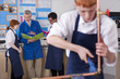 Photo: Teacher talking to students in vocational classroom Teacher talking to students in vocational classroom