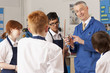 Photo: Teacher explaining plumbing faucet to students in vocational classroom Teacher explaining plumbing faucet to students in vocational classroom