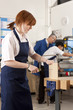 Student sawing wood in vise in vocational classroom