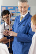 Photo: Teacher explaining plumbing faucet to students in vocational classroom Teacher explaining plumbing faucet to students in vocational classroom