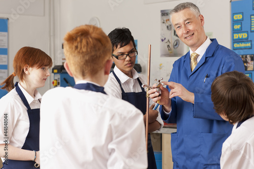 Photo: Teacher explaining plumbing faucet to students in vocational classroom Teacher explaining plumbing faucet to students in vocational classroom