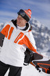 Smiling man holding snowboard