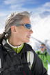 Couple hiking up ski slope on mountain