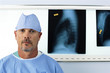 Portrait of serious surgeon in front of x-rays