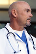 Close up of bald doctor in lab coat with stethoscope