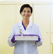 Portrait of smiling pathologist with tray of blood samples