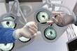 Foto: Surgeons holding scissors under lamps in operating room Surgeons holding scissors under lamps in operating room