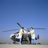Photo: Doctors and paramedics rushing patient on gurney from emergency airlift helicopter Doctors and paramedics rushing patient on gurney from emergency airlift helicopter
