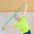 Portrait of senior man exercising with resistance band in gym