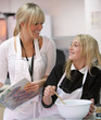 Teacher and student cooking in home economics class