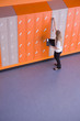 Girl opening locker in school corridor