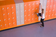 Girl opening locker in school corridor