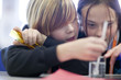 Close up of girls doing science experiment in laboratory classroom