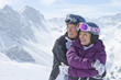 Foto: Smiling senior couple hugging on snowy mountain Smiling senior couple hugging on snowy mountain