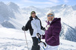 Foto: Portrait of smiling senior couple wearing sunglasses and holding ski poles on snowy mountain Portrait of smiling senior couple wearing sunglasses and holding ski poles on snowy mountain