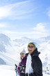 Foto: Portrait of laughing senior couple wearing sunglasses and holding ski poles on snowy mountain Portrait of laughing senior couple wearing sunglasses and holding ski poles on snowy mountain