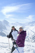 Foto: Portrait of smiling senior couple wearing sunglasses and holding ski poles on snowy mountain Portrait of smiling senior couple wearing sunglasses and holding ski poles on snowy mountain