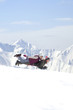 Senior couple sledding on snowy mountain