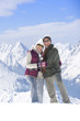Portrait of smiling senior couple standing on snowy mountain
