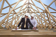 Architects reviewing blueprints at construction site