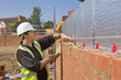 Bricklayer laying brick wall
